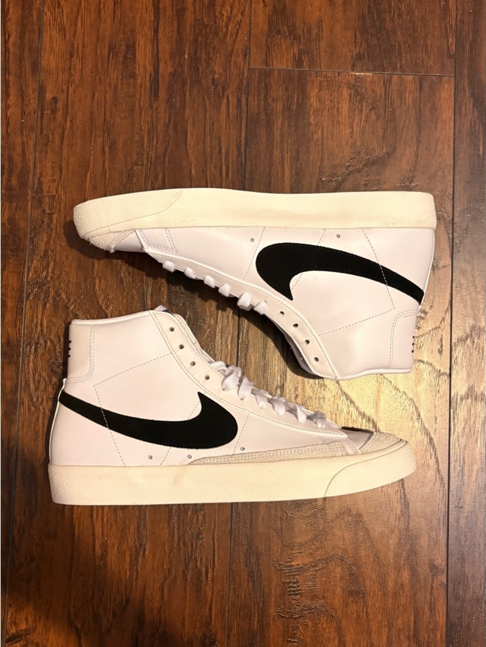 Nike White High-Top Sneakers with Black Swoosh
